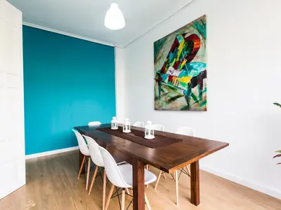 a dining room with a wooden table and white chairs at Total Valencia Terrace in Valencia