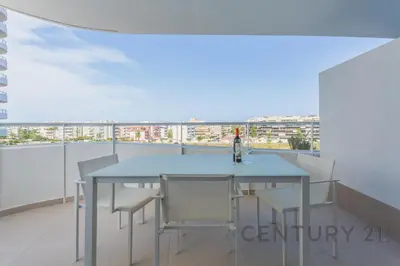 a dining room with a table and chairs on a balcony at Luxury Apartment with 2 Bedrooms in Canet d'en Berenguer, Valencia in Canet de Berenguer
