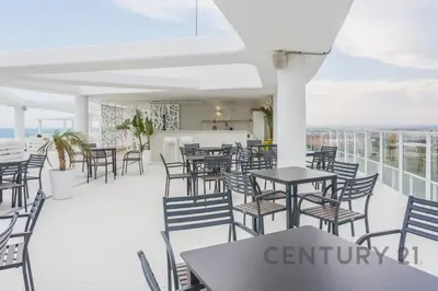 a restaurant with tables and chairs on a balcony at Luxury Apartment with 2 Bedrooms in Canet d'en Berenguer, Valencia in Canet de Berenguer