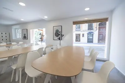 a room with tables and white chairs and a window at Residencia Universitaria Trinitarios in Valencia