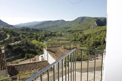 a view from the balcony of a house with mountains in the background at Casa Rural La Corretger in Chulilla