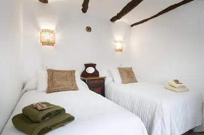 two beds with towels on them in a room at Casa Rural La Corretger in Chulilla