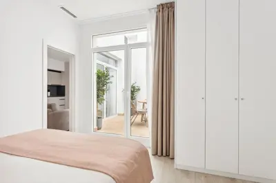 a bedroom with a bed and a large window at Limehome Valencia Calle de Cadiz in Valencia