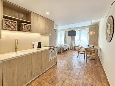 a kitchen with a sink and a table at Apartamentos Las Ciencias Studio P in Valencia