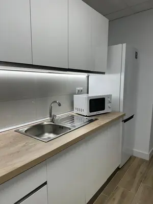a kitchen with a sink and a microwave on a counter at Apartamento Valencia 17 in Paiporta