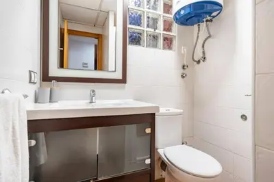 a bathroom with a toilet and a sink and a mirror at Holiday Home Valencia in Riba-Roja De Turia