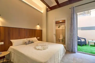 a bedroom with a bed and a sliding glass door at Buenos Aires Blues in Valencia