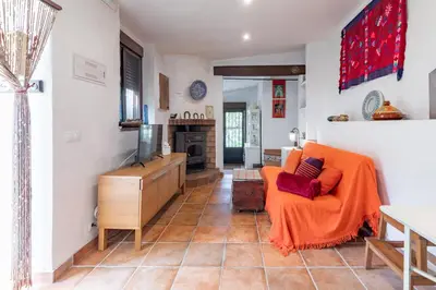 a living room with a couch and a tv at EL SECADERO in Alcudia de Veo