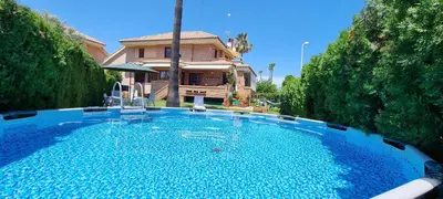 a large swimming pool in front of a house at Casa en la playa in Sagunto