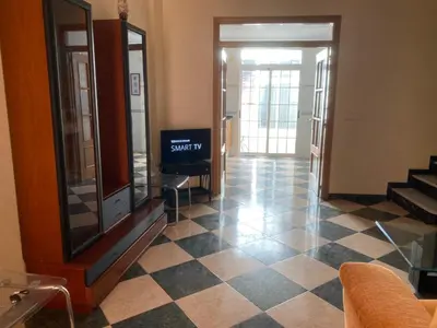 a living room with a tiled floor and a tv at MAR i MONTAÑA en Cullera Villa Juani in Cullera