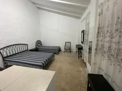 a room with two beds and a table in it at MAR i MONTAÑA en Cullera Villa Juani in Cullera
