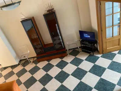 a room with a tv and two chairs and a mirror at MAR i MONTAÑA en Cullera Villa Juani in Cullera