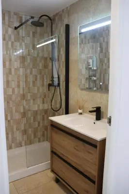 a bathroom with a sink and a shower at Precioso apartamento con vistas al mar. Piscina. in Valencia