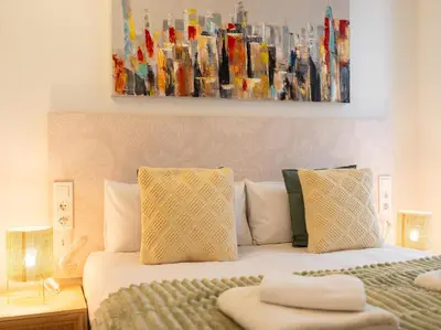 a bedroom with a bed with a painting on the wall at Central Market - Ciutat Vella, exclusively for families - Mid-term in Valencia