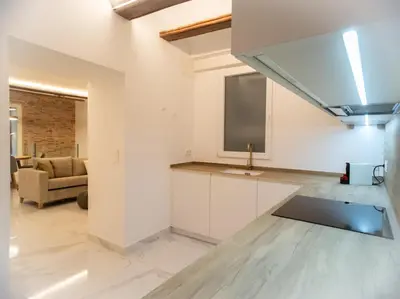 a kitchen with a tv and a living room at Central Market - Ciutat Vella, exclusively for families - Mid-term in Valencia