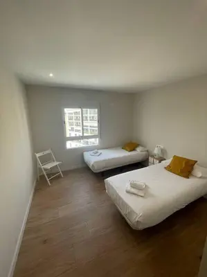 a room with two beds and a window at Apartamento WELCOME céntrico de diseño en calle Tres Forques in Valencia