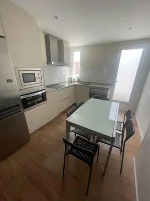 a kitchen with a table and chairs in a room at Apartamento WELCOME céntrico de diseño en calle Tres Forques in Valencia