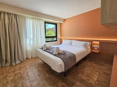 a bedroom with a bed with two towels on it at Apartamentos Las Ciencias R in Valencia