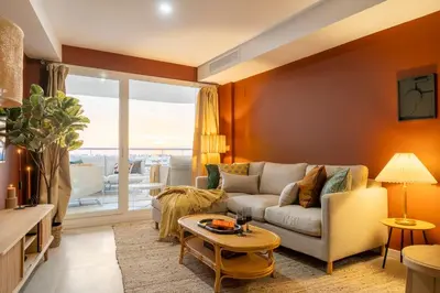 a living room with a couch and a table at Gran Canet 2BR! Walk to Beach, Sea View, Sauna & Gym in Canet de Berenguer