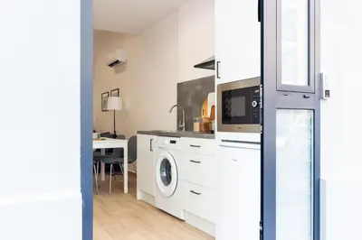 a kitchen with a washer and dryer in a room at VLC HOST- Fray Pedro in Valencia