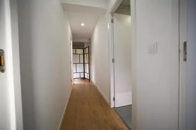 an empty hallway with white walls and wooden floors at Casa Ross en Ruzafa in Valencia