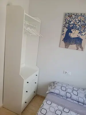a white bedroom with a bed and a dresser and a drawer at Apartamento en el Grau de Moncofa entre 2 y 3 linea de playa in Moncófar