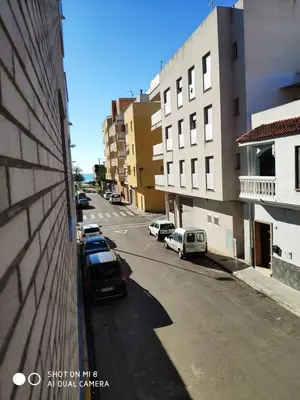 a street with cars parked on the side of a building at Apartamento en el Grau de Moncofa entre 2 y 3 linea de playa in Moncófar