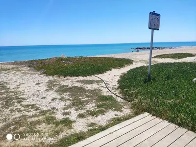 a sign on a beach with the ocean in the background at Apartamento en el Grau de Moncofa entre 2 y 3 linea de playa in Moncófar