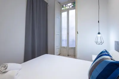 a white room with a white table and a window at FLORIT FLATS - The Vella Apartment in Valencia
