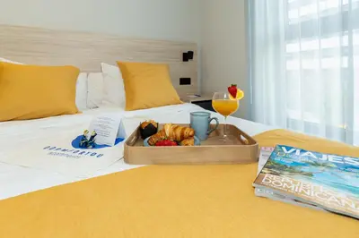 a tray of food and a drink on a bed at Dorm4You Arena 2 in Valencia