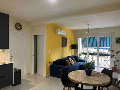 a living room with a blue couch and a table at Modern apartment in heart of city in Valencia