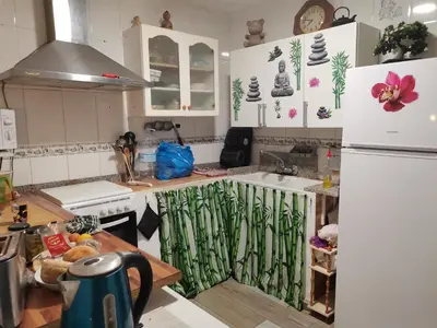 a kitchen with a white refrigerator and a sink at Rony in Llaurí