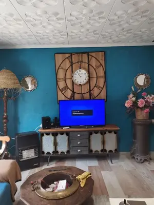 a living room with a clock on the wall at Rony in Llaurí