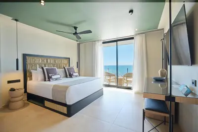 a bedroom with a bed and a view of the ocean at ESTIMAR Marina Farnals in Puebla de Farnals
