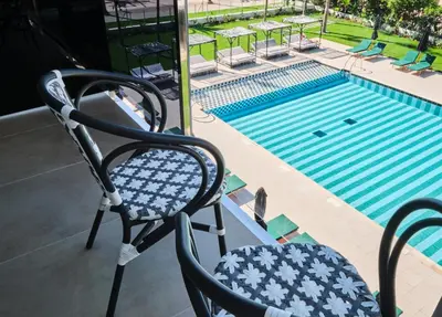 a pair of chairs sitting next to a swimming pool at ESTIMAR Marina Farnals in Puebla de Farnals
