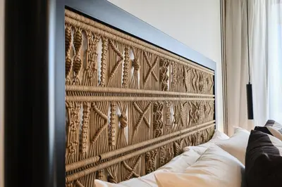 a large wooden headboard in a room with a couch at ESTIMAR Marina Farnals in Puebla de Farnals