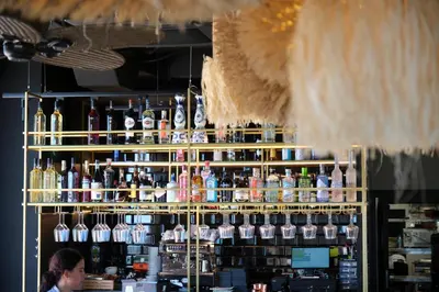 a bar with a lot of bottles of alcohol at ESTIMAR Marina Farnals in Puebla de Farnals