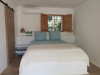 a bedroom with a large bed with blue pillows at Relais Pollo Loco in Valencia