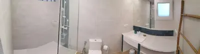 a white bathroom with a sink and a toilet at Relais Pollo Loco in Valencia