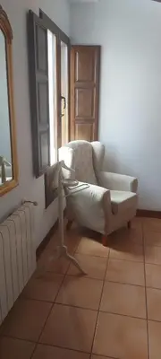 a living room with a chair and a window at El Pino B & B, Chera in Valencia