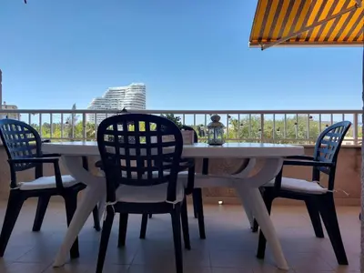 a table and chairs on a balcony with a view at CANET PLAYA MAGNIFICO APTO FAMILIAR con PISCINA y GARAJE in Canet de Berenguer