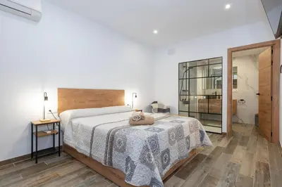 a bedroom with a bed with a teddy bear on it at Casa Rural Sarsalet in Chella