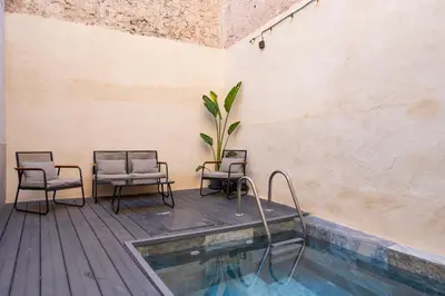 a patio with chairs and a swimming pool at Casa Rural Sarsalet in Chella