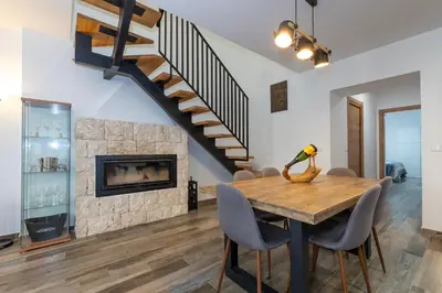 a dining room with a table and a fireplace at Casa Rural Sarsalet in Chella