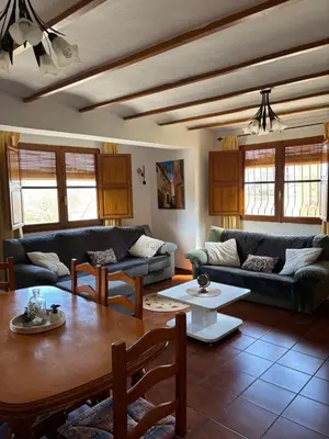 a living room with couches and a table at RuralRusticHome in Altura