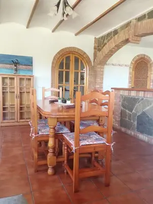 a dining room with a wooden table and chairs at RuralRusticHome in Altura