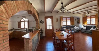 a kitchen and a living room with a table at RuralRusticHome in Altura