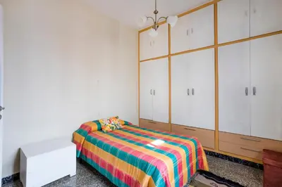 a bedroom with a bed and white cabinets at Casa con terraza en Sierra de Espadán in Vall de Uixó
