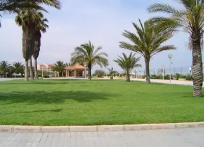 a park with palm trees and a field of grass at Vistas al mar en Canet Playa WIFI in Canet de Berenguer