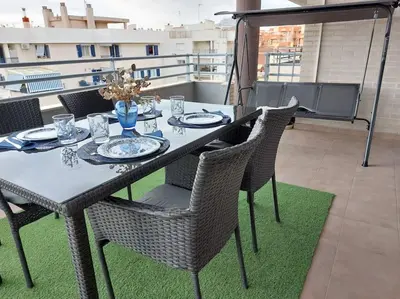 a dining table and chairs on a balcony at Vistas al mar en Canet Playa WIFI in Canet de Berenguer